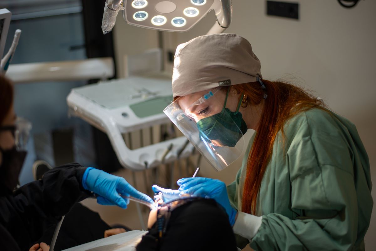 dentist performing a dental procedure with her assistant